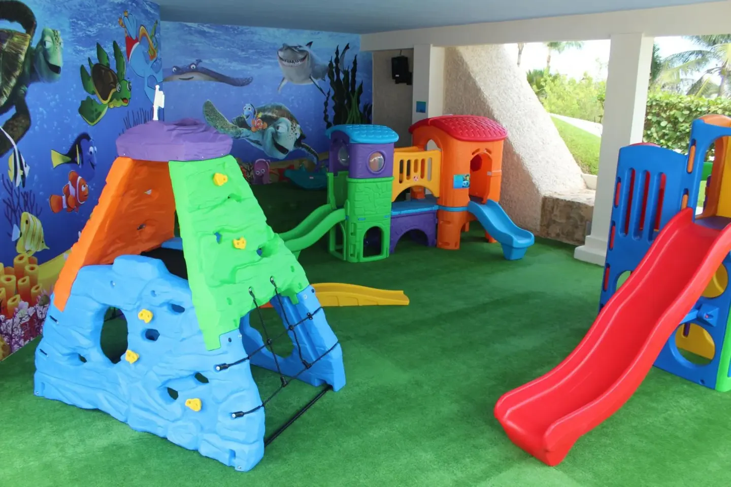 Indoor children's play area with slides and ocean murals at Royal Solaris Cancun.
