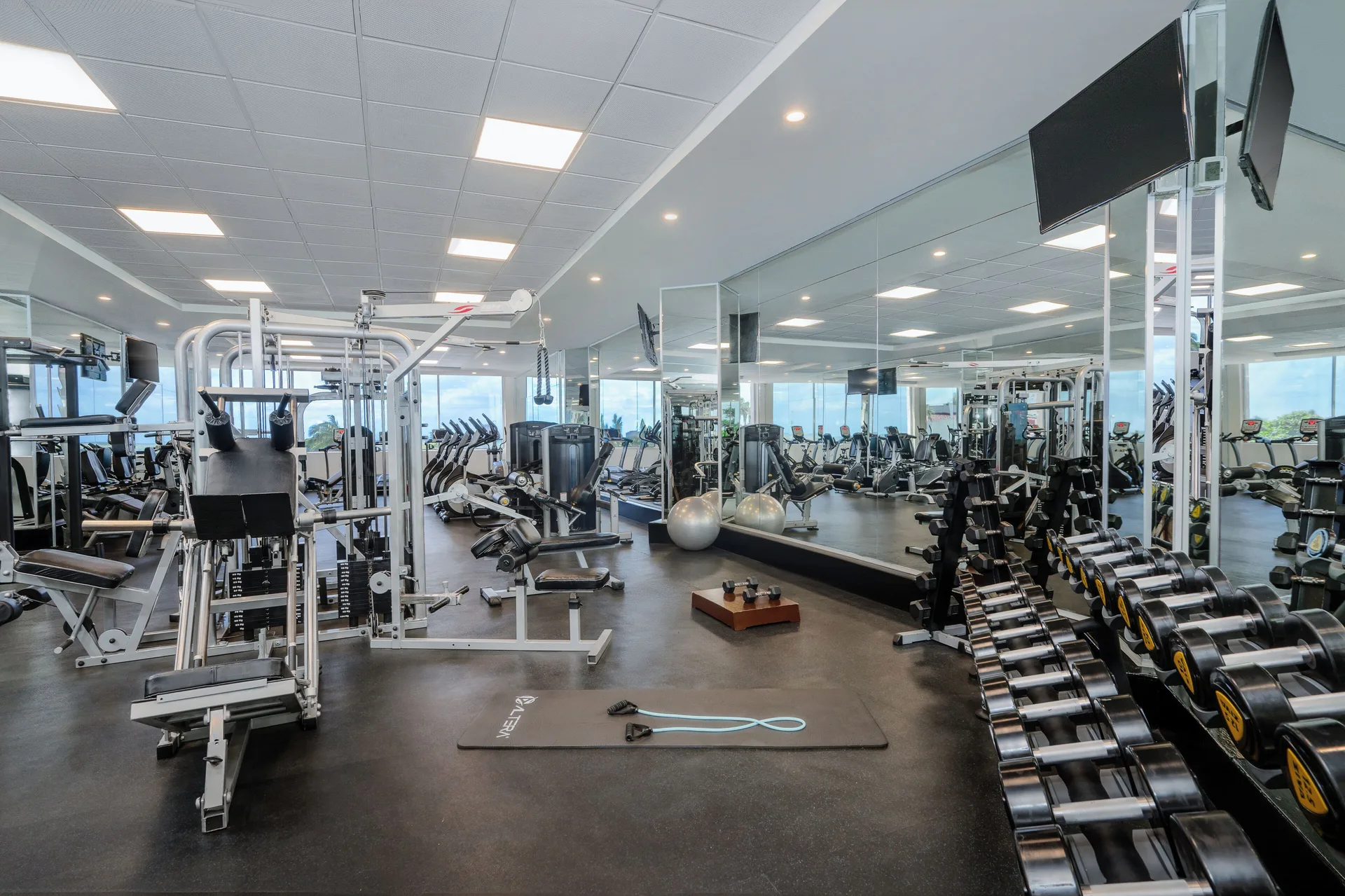 Fitness center with weights, cardio machines, and mirrors at Royal Solaris Cancun.