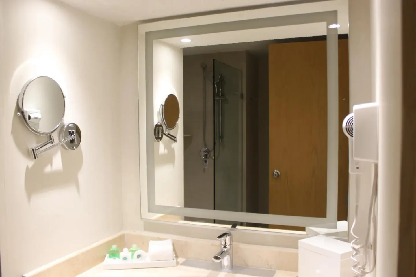 Bathroom vanity with mirror, sink, hair dryer and amenities at Royal Solaris Cancun.