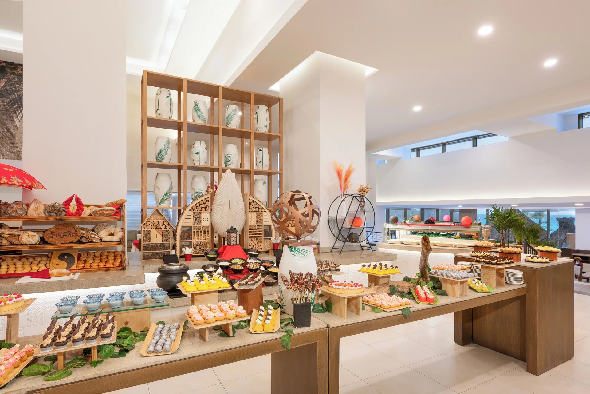 Dessert buffet with pastries, fruit, and display stands at Royal Solaris Cancun.