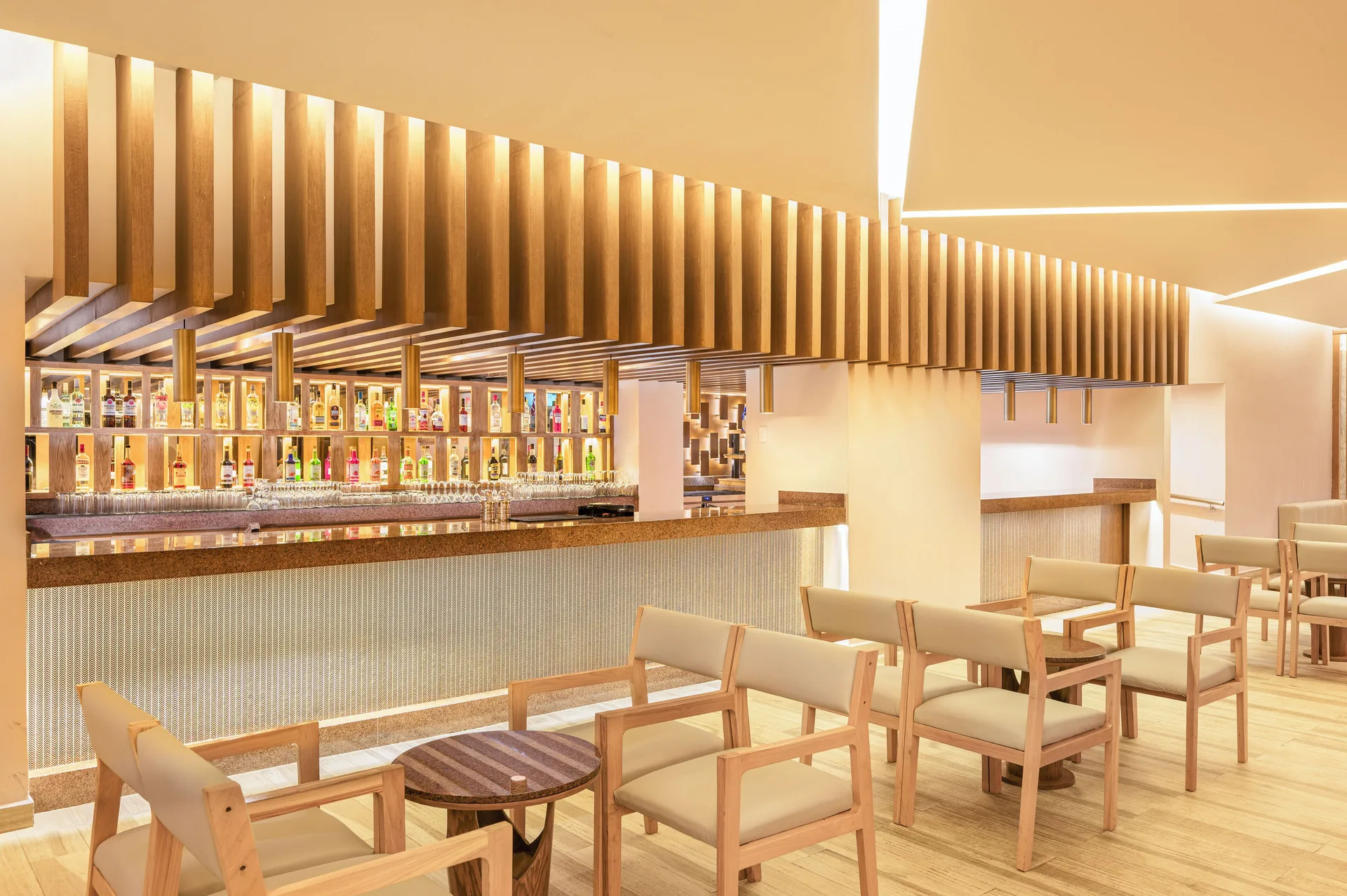 Lobby Bar seating and illuminated liquor shelves at Royal Solaris Cancun.