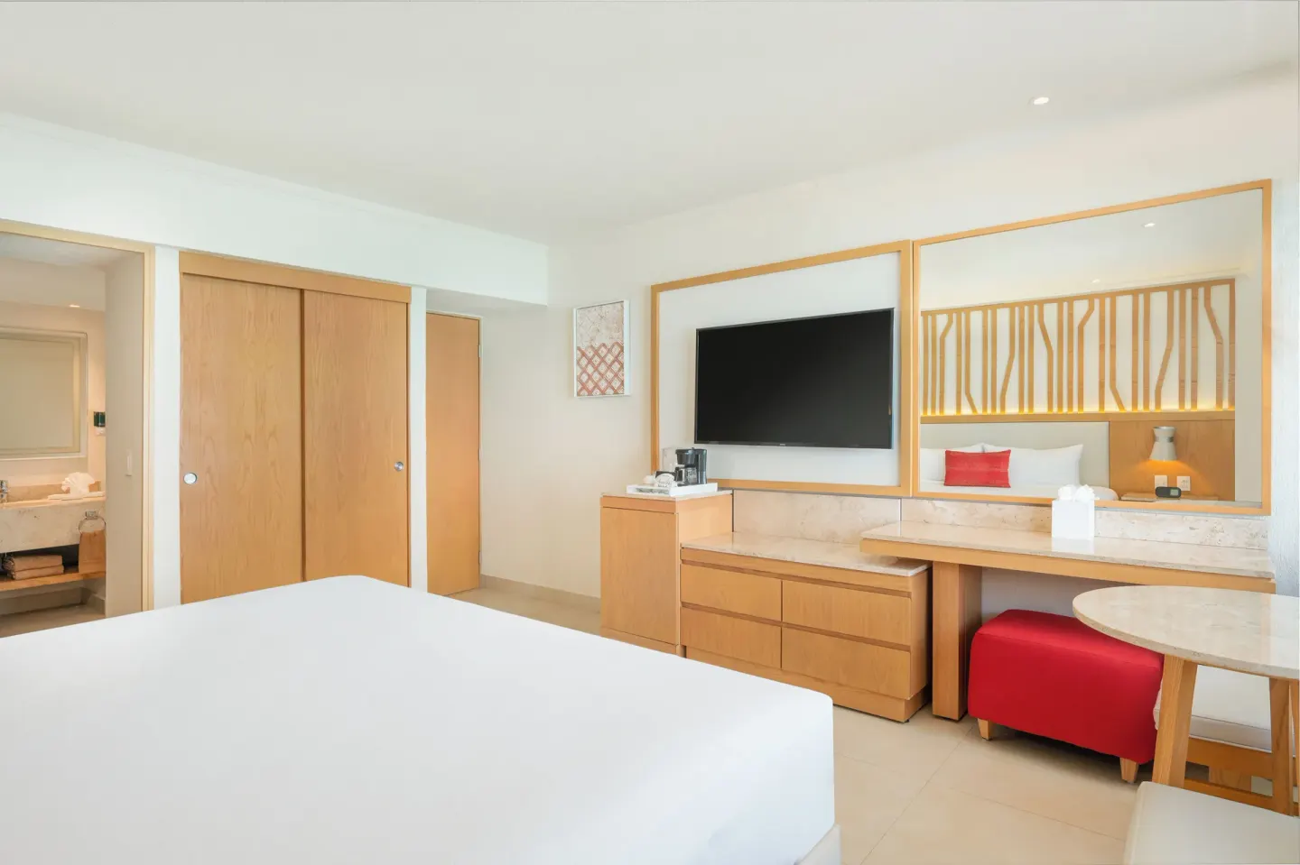 Deluxe Lagoon Room with king bed, TV wall, closet, and vanity at Royal Solaris Cancun.
