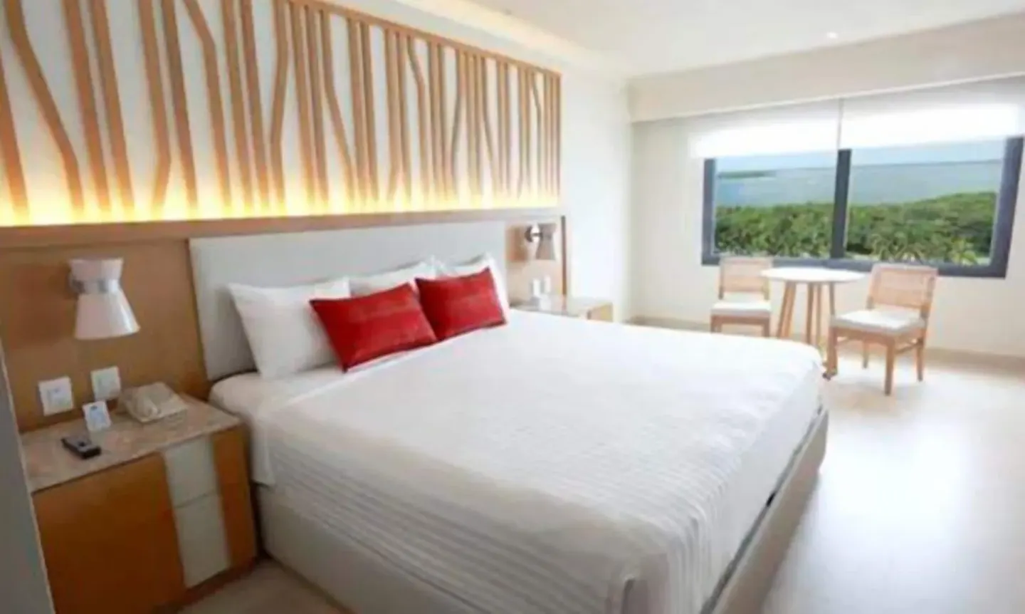 Deluxe Lagoon Room with king bed and window view at Royal Solaris Cancun.