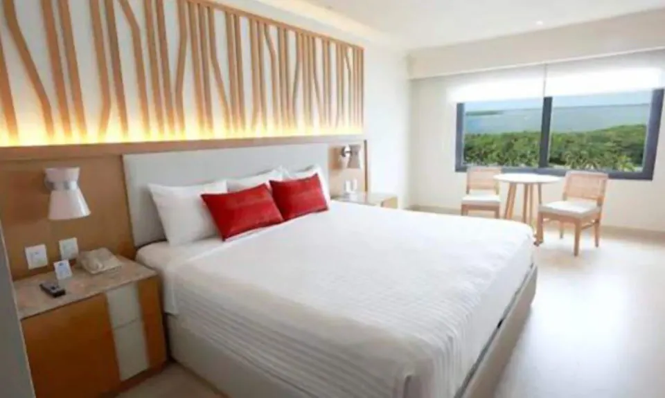 Deluxe Lagoon Room with king bed and window view at Royal Solaris Cancun.
