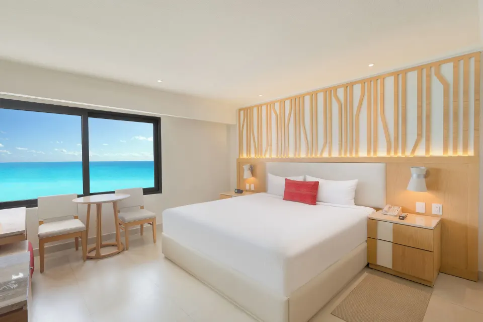 Deluxe Ocean View room with king bed and sea-facing window at Royal Solaris Cancun.