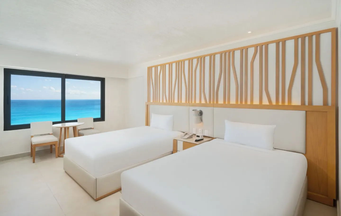 Deluxe Ocean View room with two beds and a turquoise sea view at Royal Solaris Cancun.