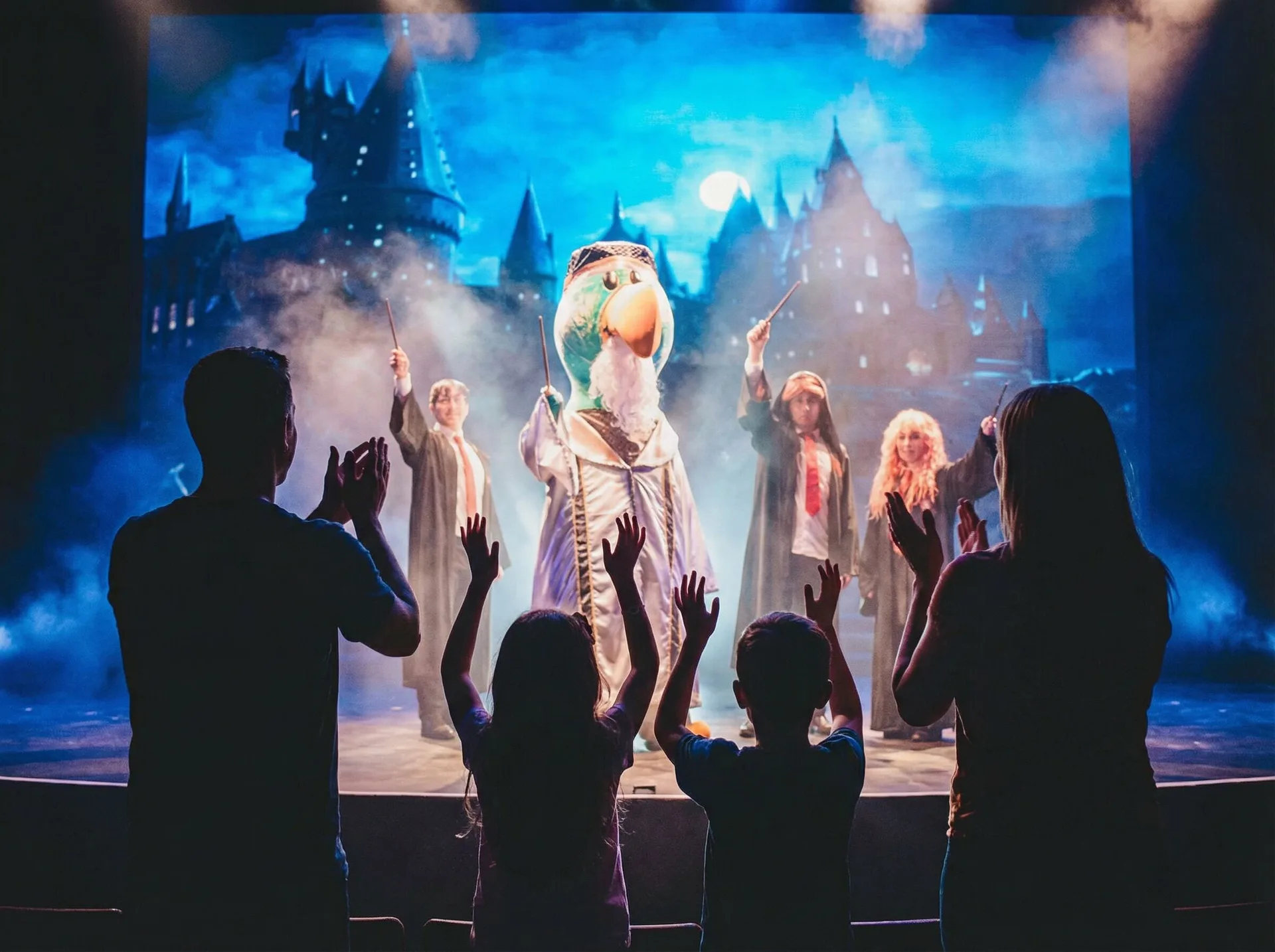 Family watches a costumed stage show at Royal Solaris Los Cabos & Spa.