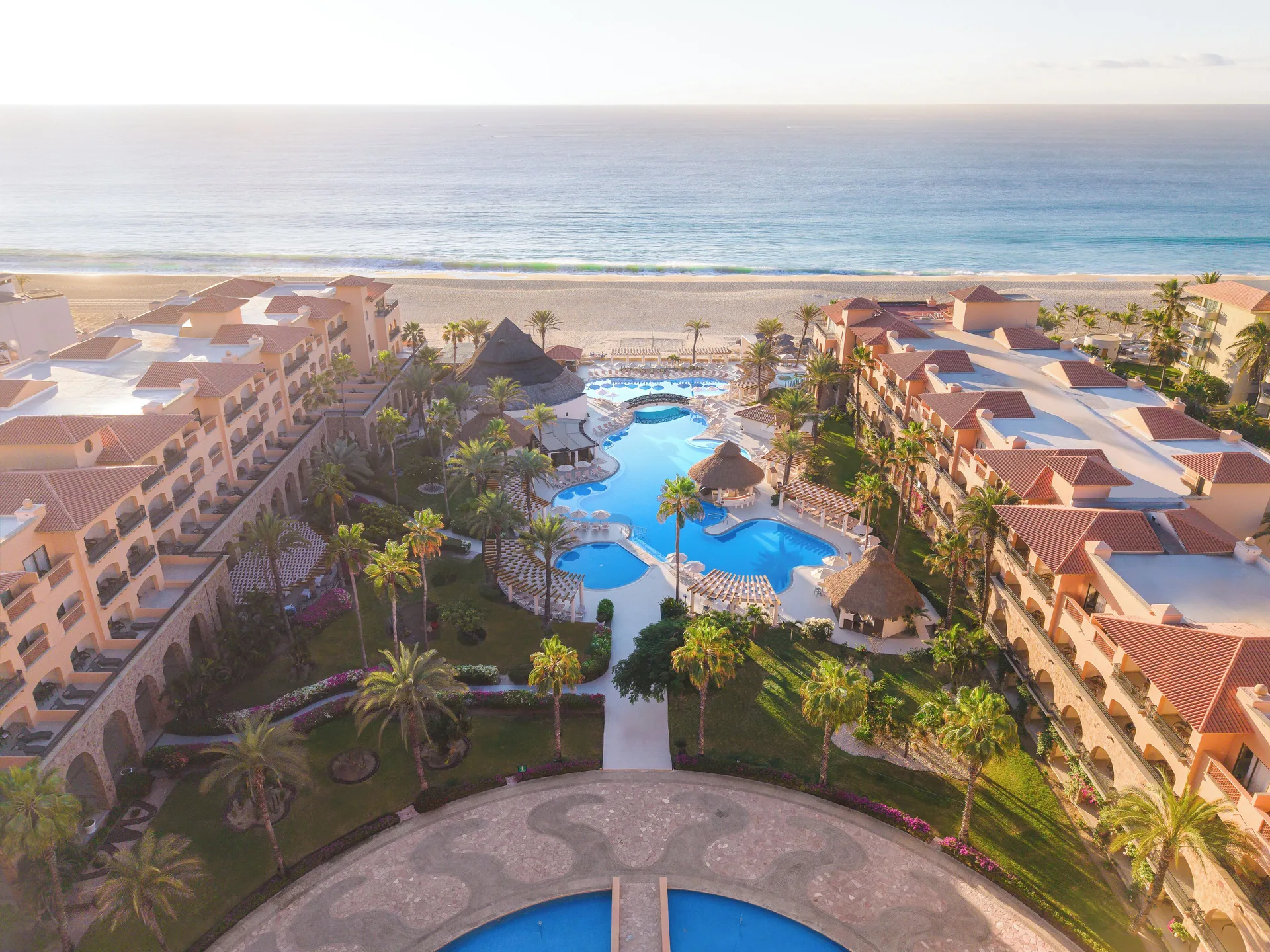 Aerial view of pools, gardens, beachfront buildings and ocean at Royal Solaris Los Cabos & Spa.