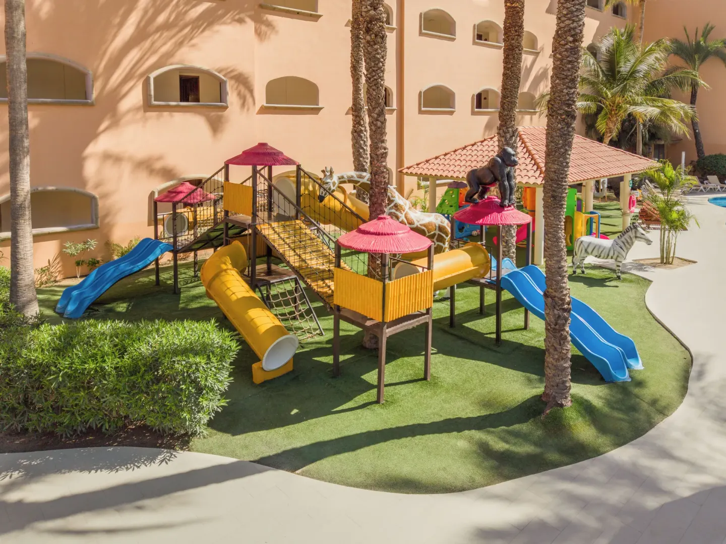 Outdoor playground with slides and animal figures at Royal Solaris Los Cabos & Spa.