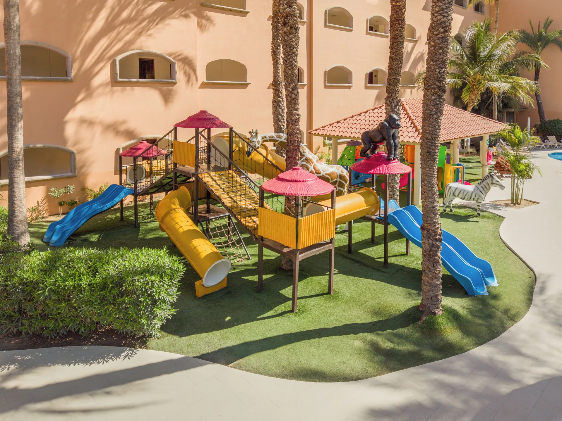Outdoor playground with slides and animal figures at Royal Solaris Los Cabos & Spa.