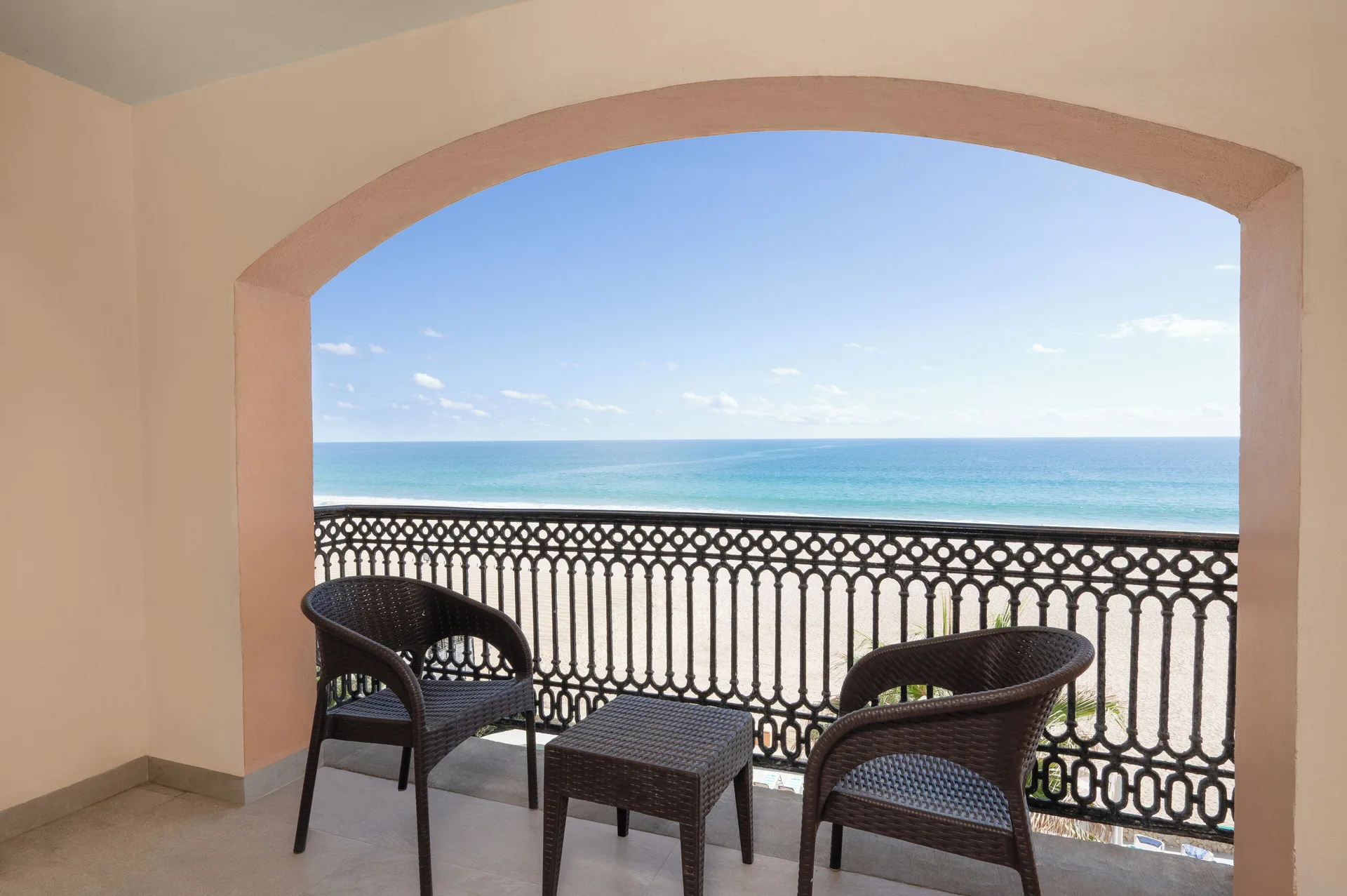 Oceanfront balcony with two chairs at Royal Solaris Los Cabos & Spa.