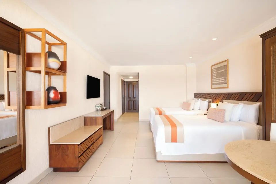 Deluxe Oceanfront room with two beds and wood furnishings at Royal Solaris Los Cabos & Spa.