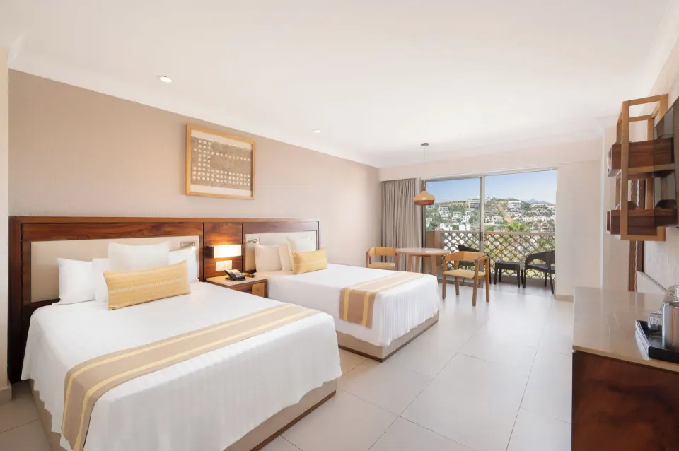 Deluxe Room with two beds and balcony view at Royal Solaris Los Cabos & Spa.