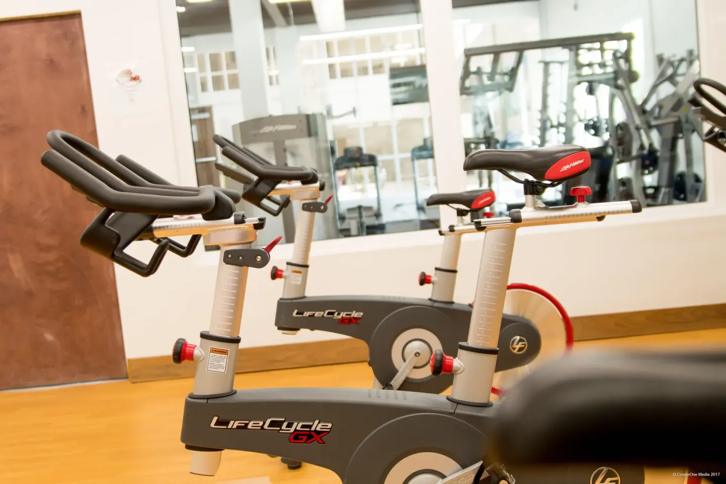 Stationary bikes on a wood-floor studio area at Royal St. Kitts Hotel.