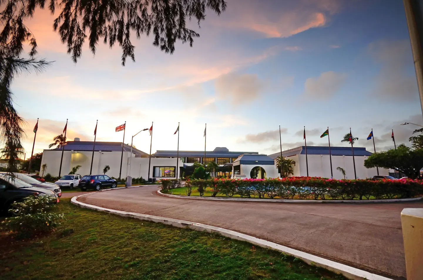 Resort entrance with flags and circular driveway at Royal St. Kitts Hotel.