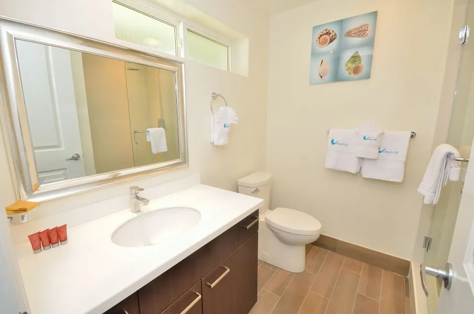 Deluxe Studio Room bathroom with vanity and towels at Royal St. Kitts Hotel.