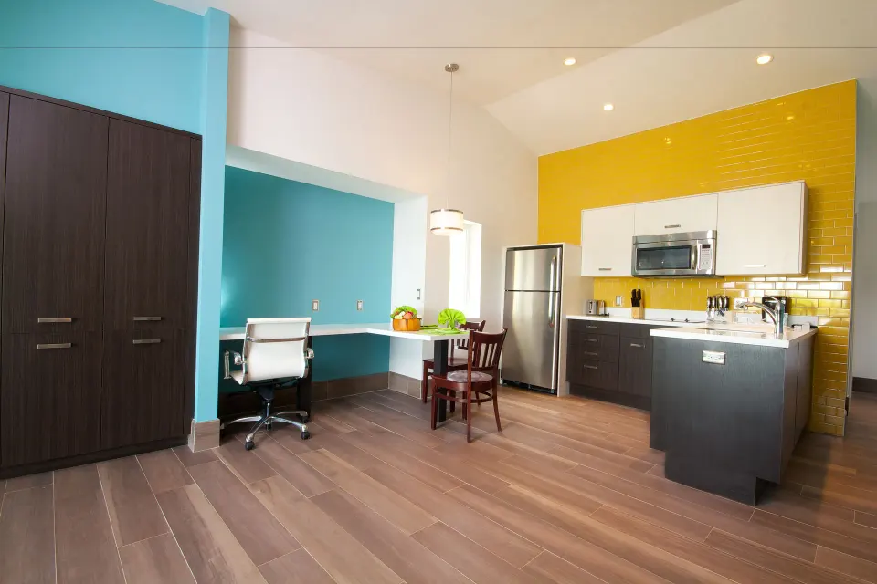 Deluxe Studio Room workspace, wardrobe, and kitchenette at Royal St. Kitts Hotel.