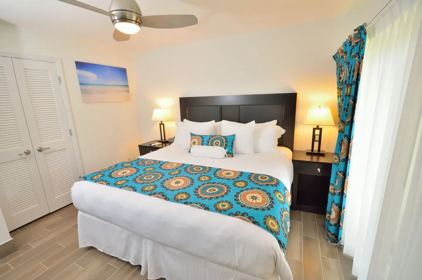 Premium Apartment 1 Bedroom with king bed and blue patterned accents at Royal St. Kitts Hotel.