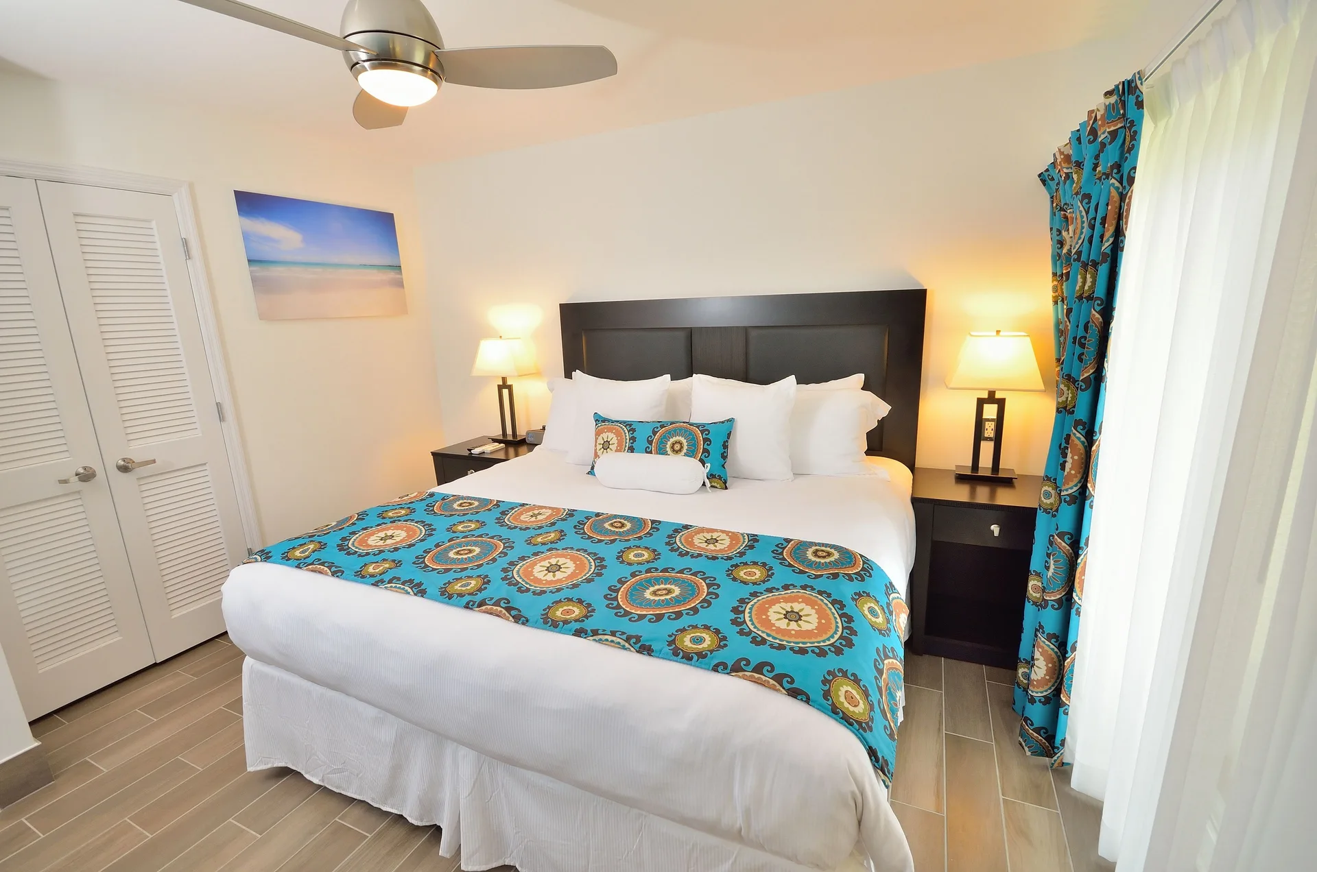 Premium Apartment 1 Bedroom with king bed and blue patterned accents at Royal St. Kitts Hotel.