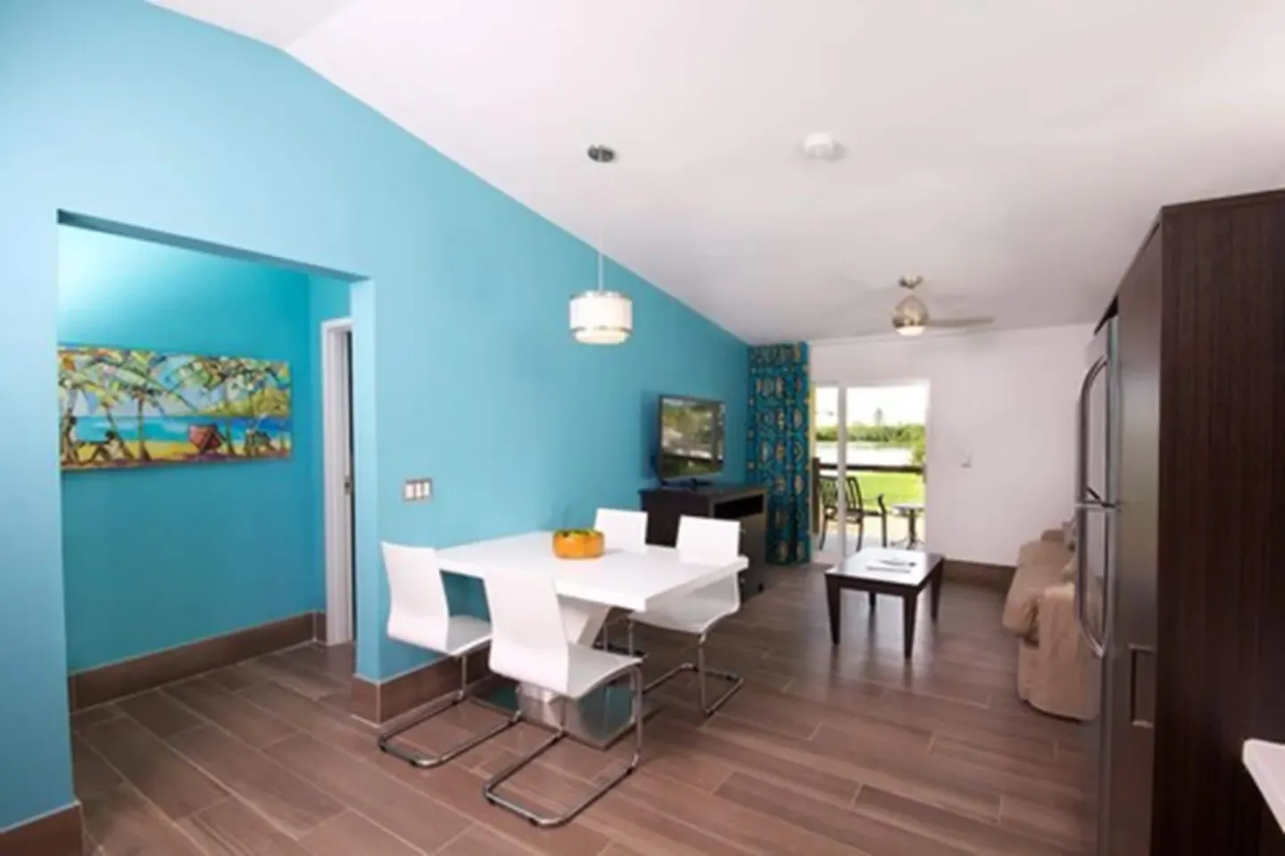 Premium Apartment 1 Bedroom living and dining area with balcony doors at Royal St. Kitts Hotel.