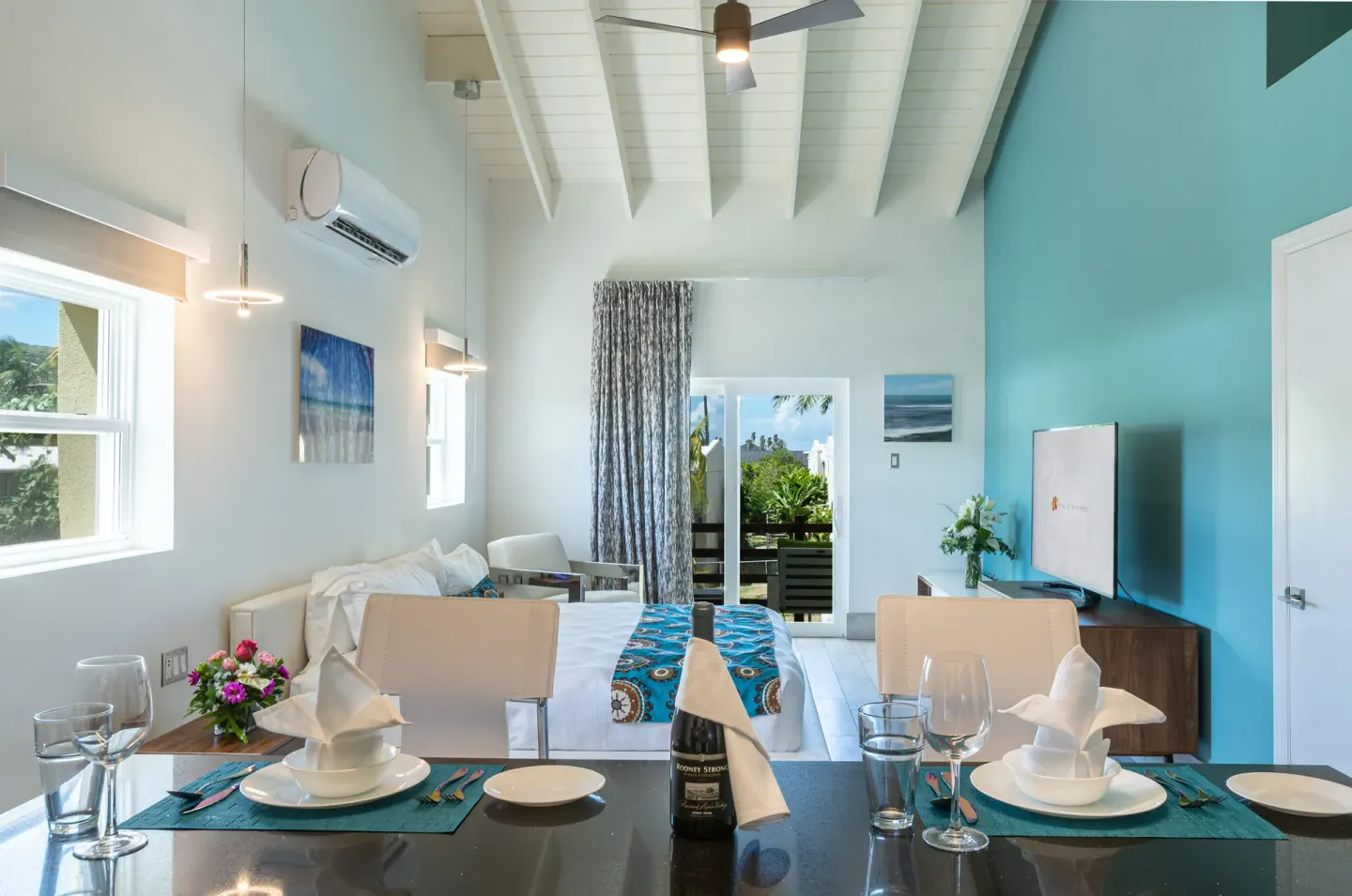 Superior Studio Poolside dining table and king bed at Royal St. Kitts Hotel.