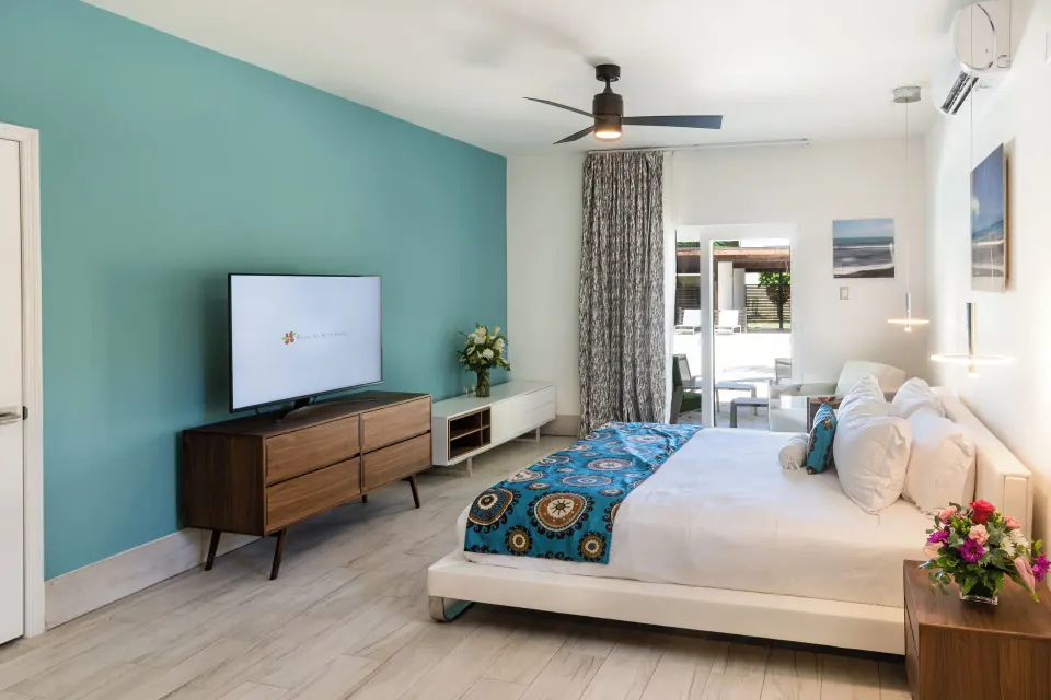 Superior Studio Poolside king bed and TV area at Royal St. Kitts Hotel.