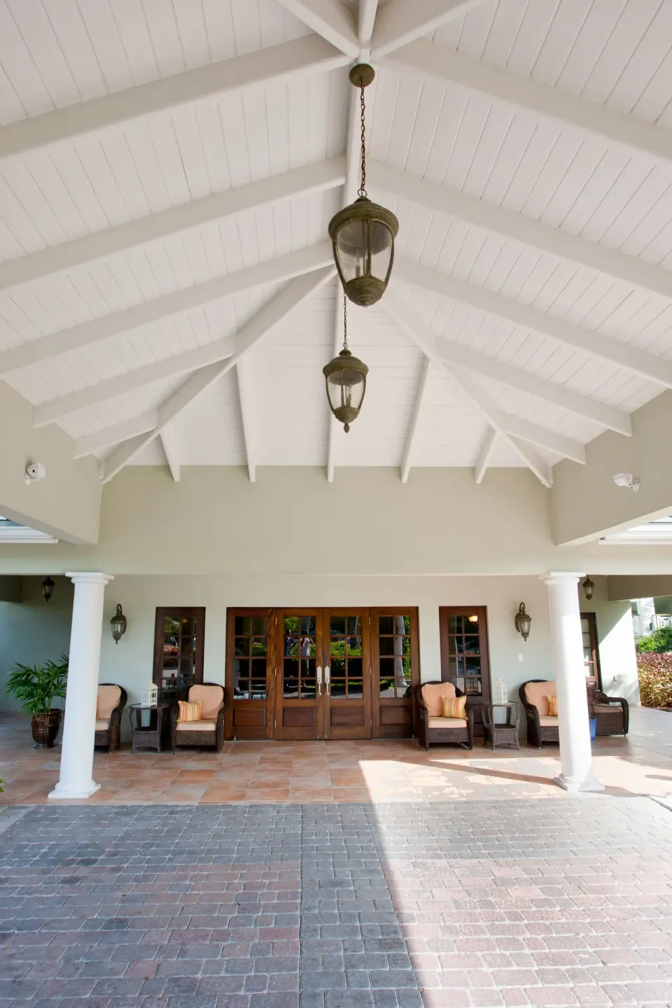 Covered lobby entrance with white vaulted ceiling at Royal West Indies Resort.
