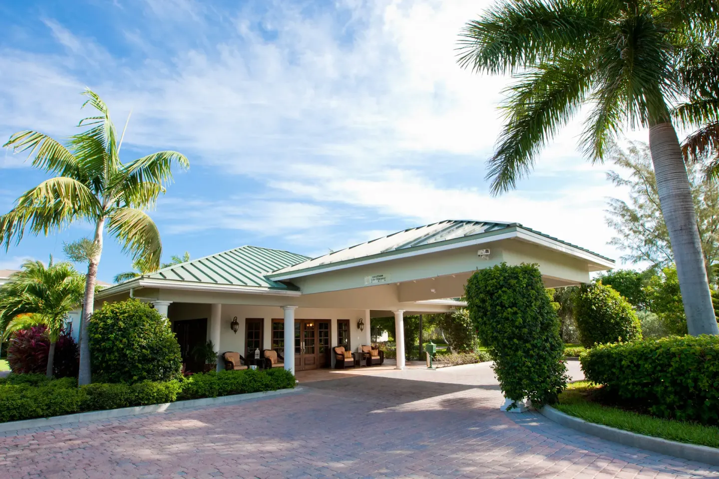 Entrance porte cochere with palms and gardens at Royal West Indies Resort.