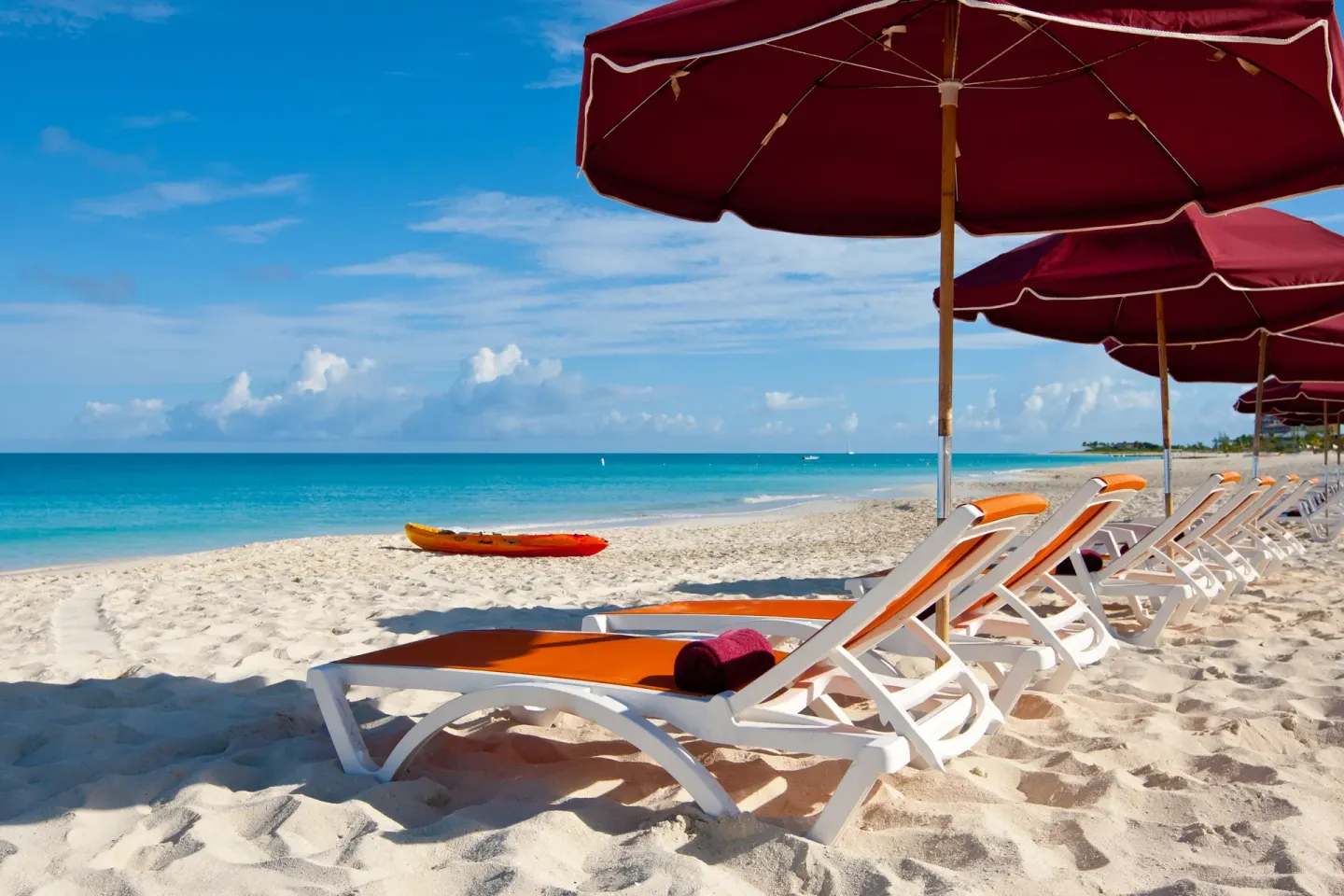 Shaded beach loungers facing the ocean at Royal West Indies Resort.