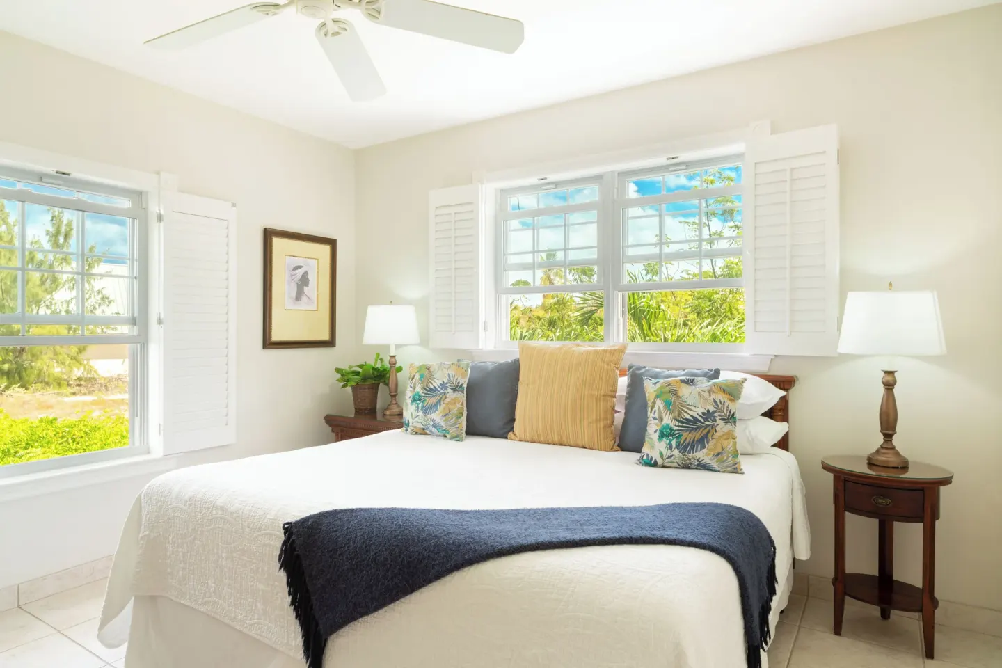 One bedroom garden view condo bedroom with leafy window views at Royal West Indies Resort.