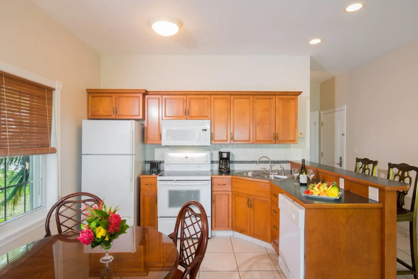 One bedroom garden view condo kitchen and dining table at Royal West Indies Resort.