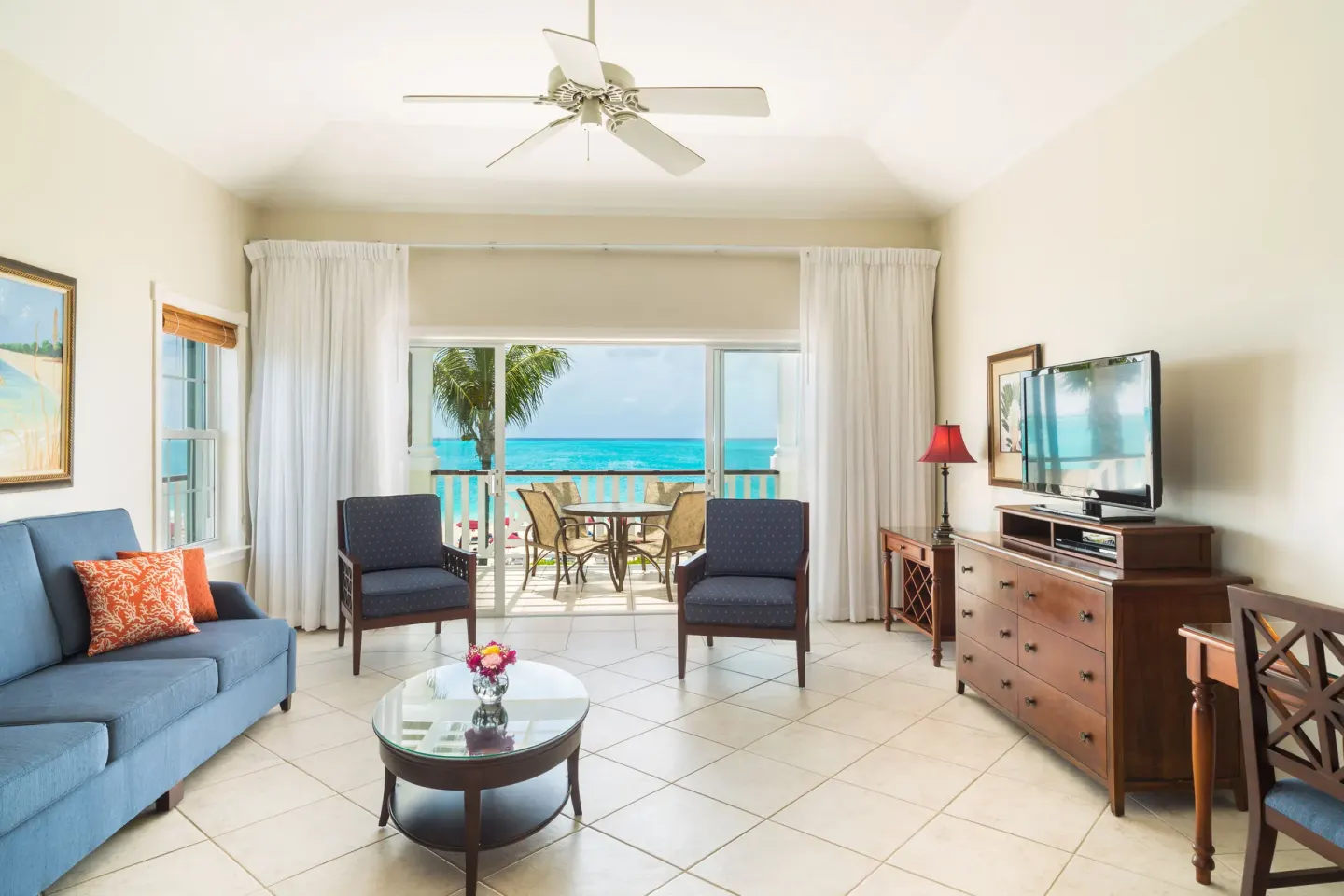 One-bedroom condo living room with balcony and ocean view at Royal West Indies Resort.