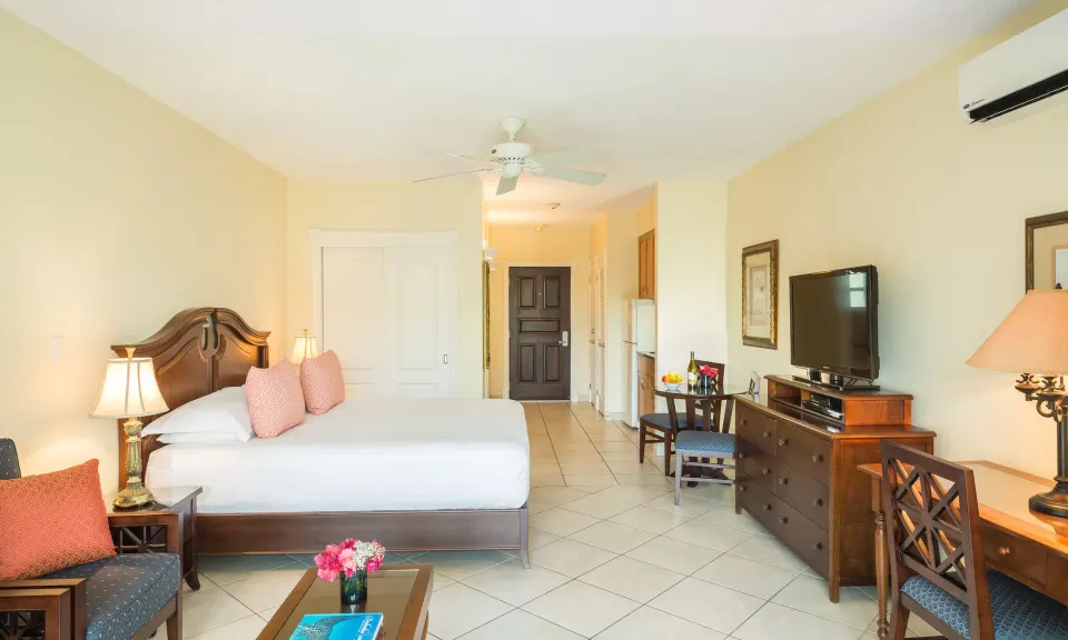 Studio Botanical View room with king bed, seating area, desk and kitchenette at Royal West Indies Resort.