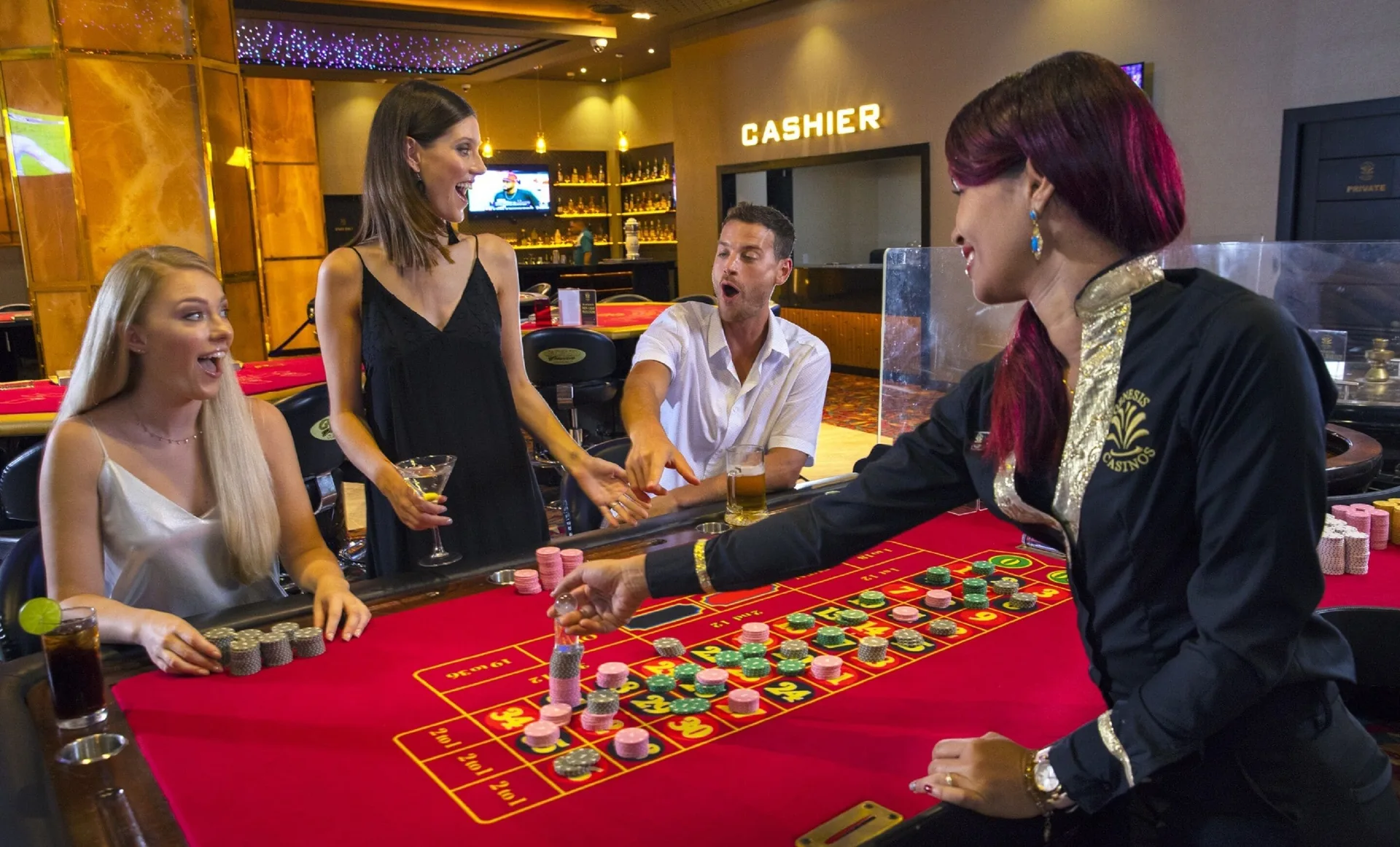 Guests play a red felt table game in the casino at Royalton Bavaro Resort & Casino.