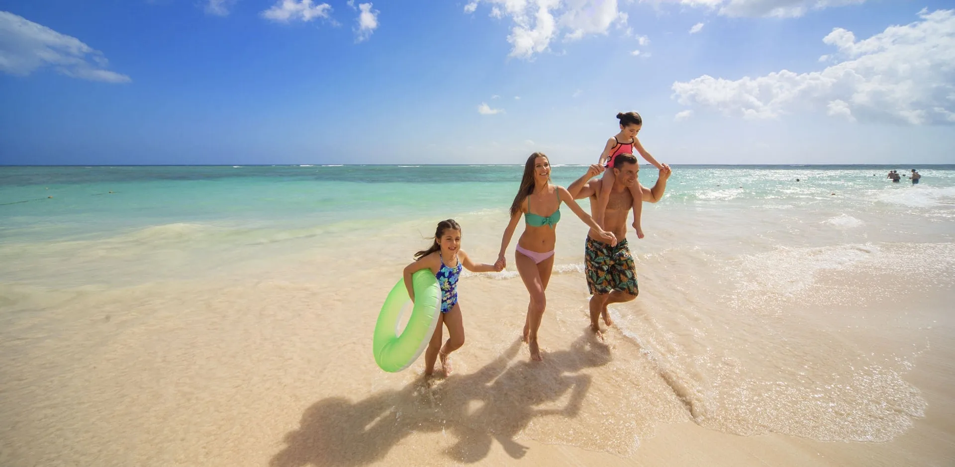 Family walking along the beach at Royalton Bavaro Resort & Casino.