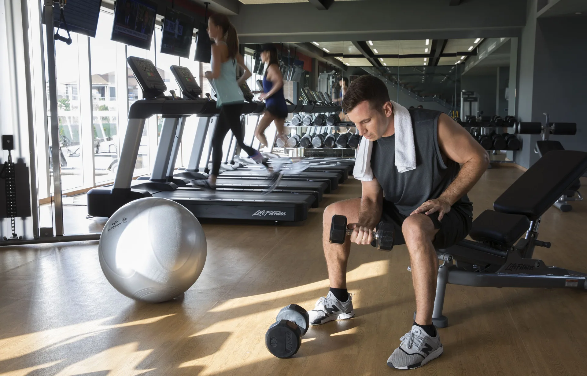 Guests work out with treadmills and dumbbells in the fitness center at Royalton Bavaro Resort & Casino.