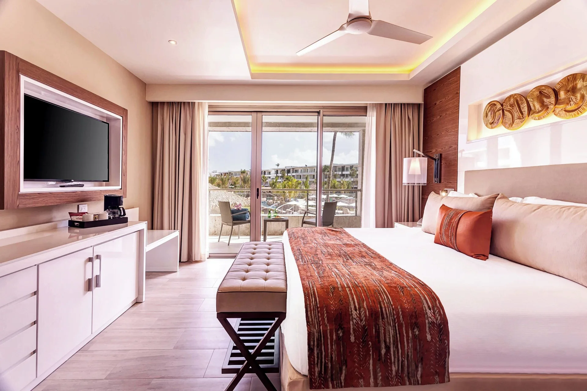 King bed guest room with balcony at Royalton Bavaro Resort & Casino.