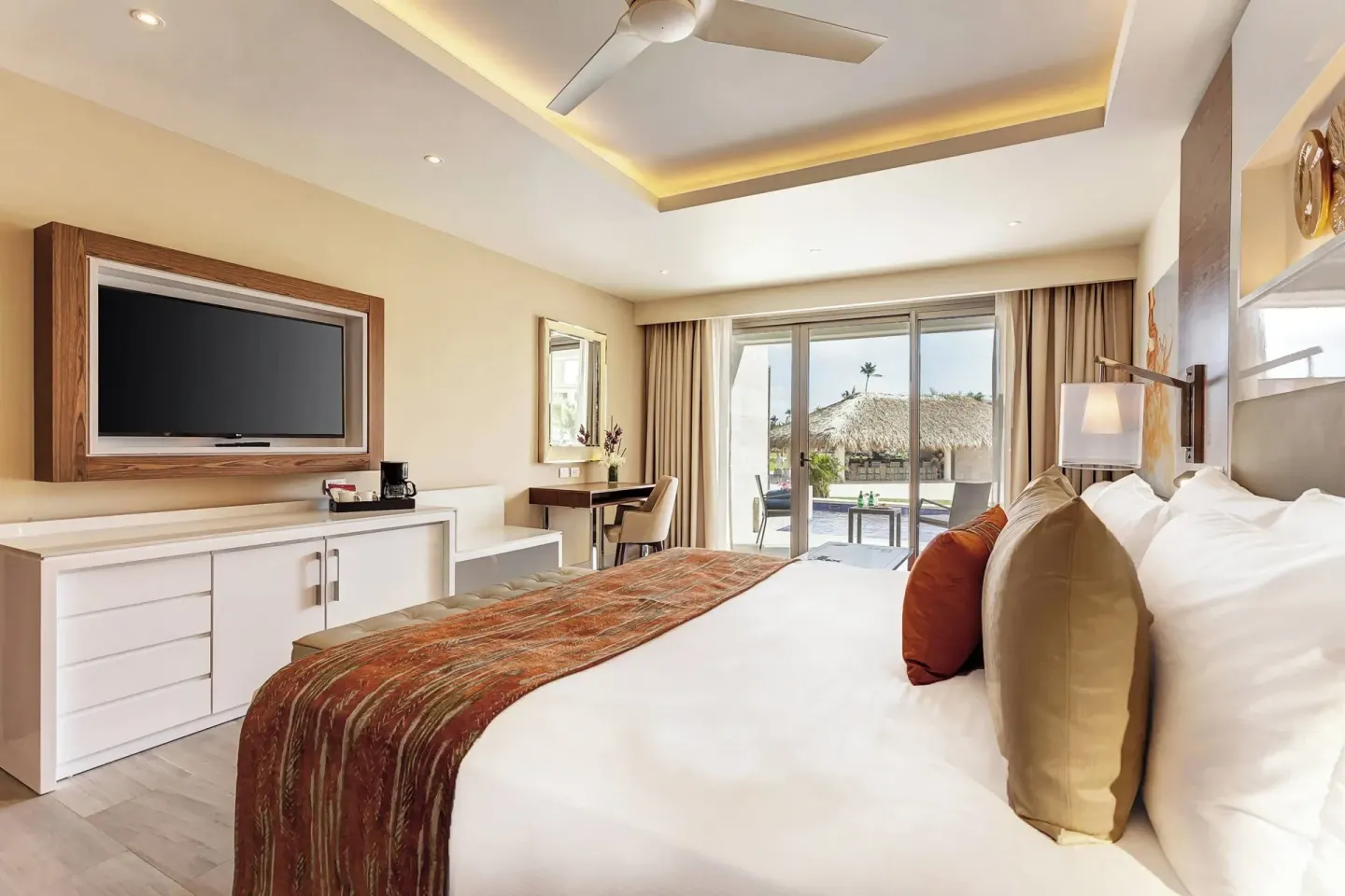 King bed guest room with patio doors at Royalton Bavaro Resort & Casino.