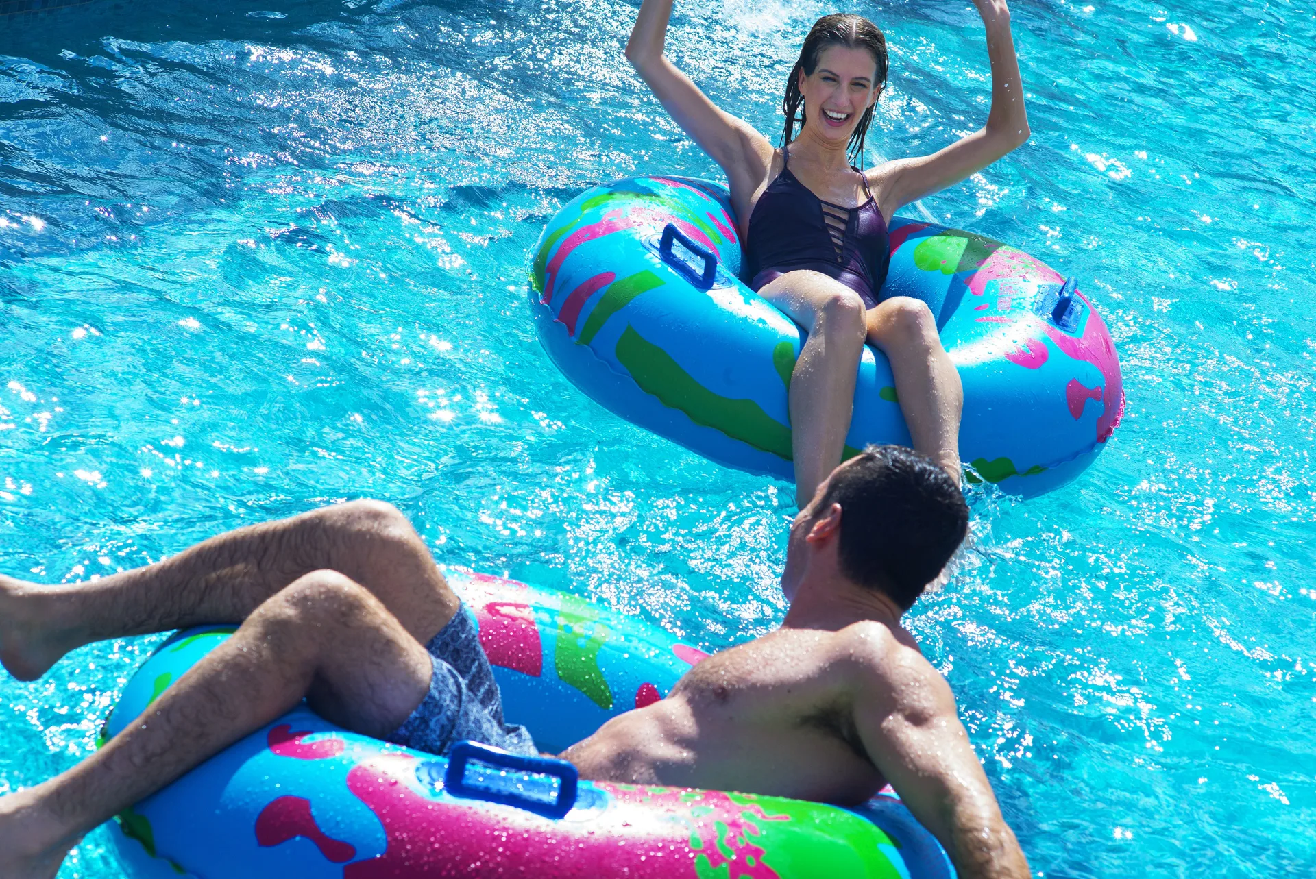 Guests floating on colorful tubes in the pool at Royalton Bavaro Resort & Casino.