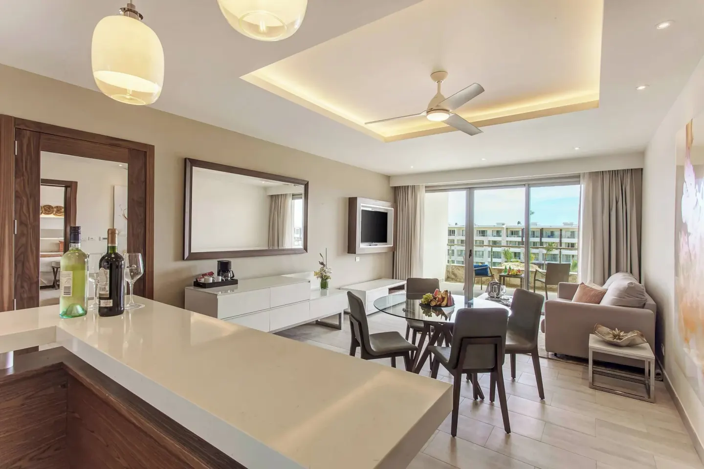 Bright suite living and dining area with balcony at Royalton Bavaro Resort & Casino.