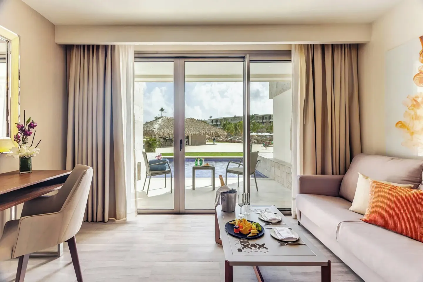 Suite sitting area with terrace access at Royalton Bavaro Resort & Casino.