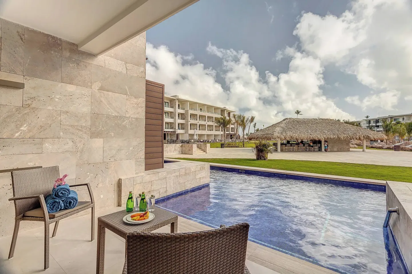 Swim-out terrace with chairs beside the pool at Royalton Bavaro Resort & Casino.
