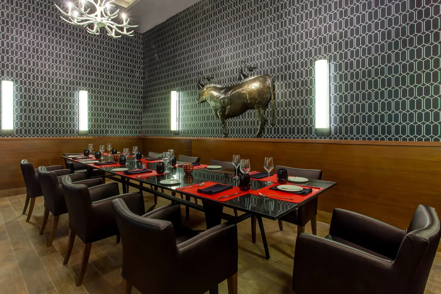 Private steakhouse dining room at Royalton Bavaro Resort & Casino with a bull sculpture on the wall.