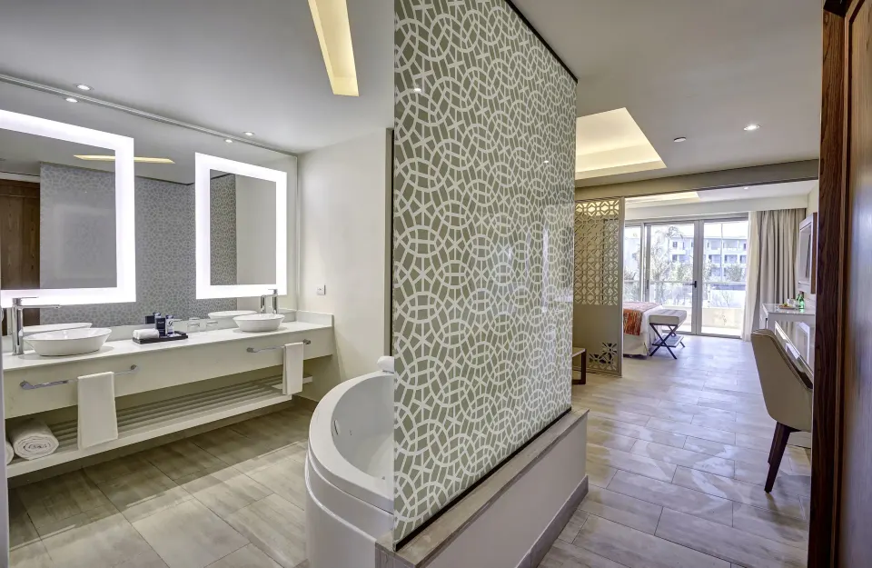 Luxury Family Suite bathroom and balcony-facing bedroom at Royalton Bavaro Resort & Casino.