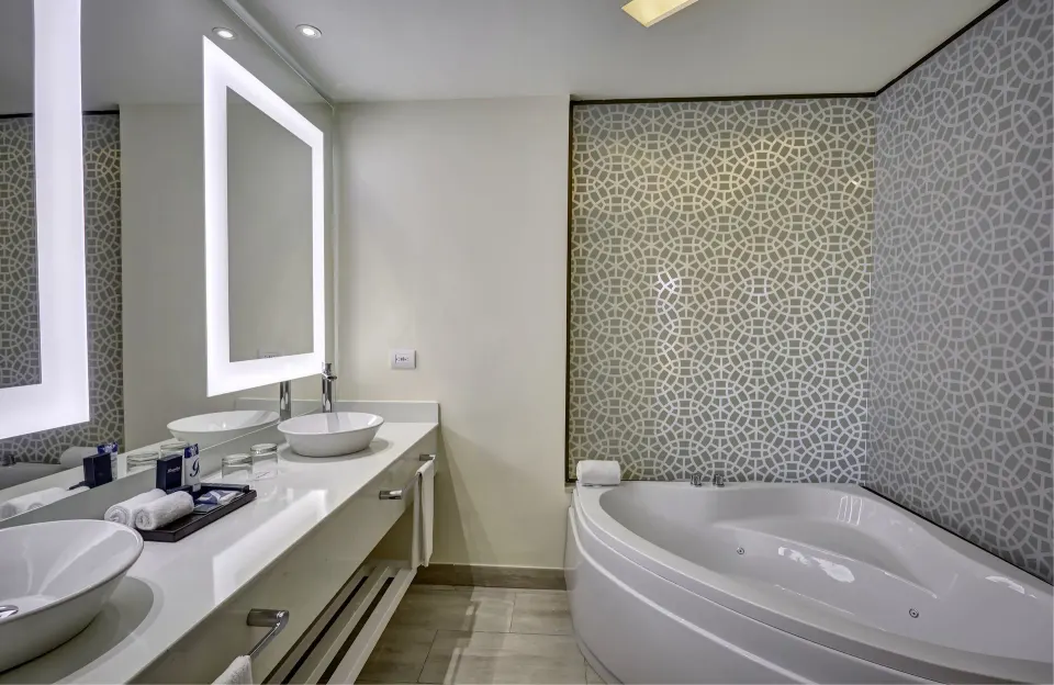 Luxury Family Suite bathroom with double sinks and tub at Royalton Bavaro Resort & Casino.