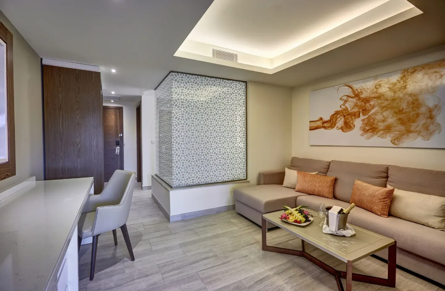 Luxury Family Suite living area with sofa and desk at Royalton Bavaro Resort & Casino.