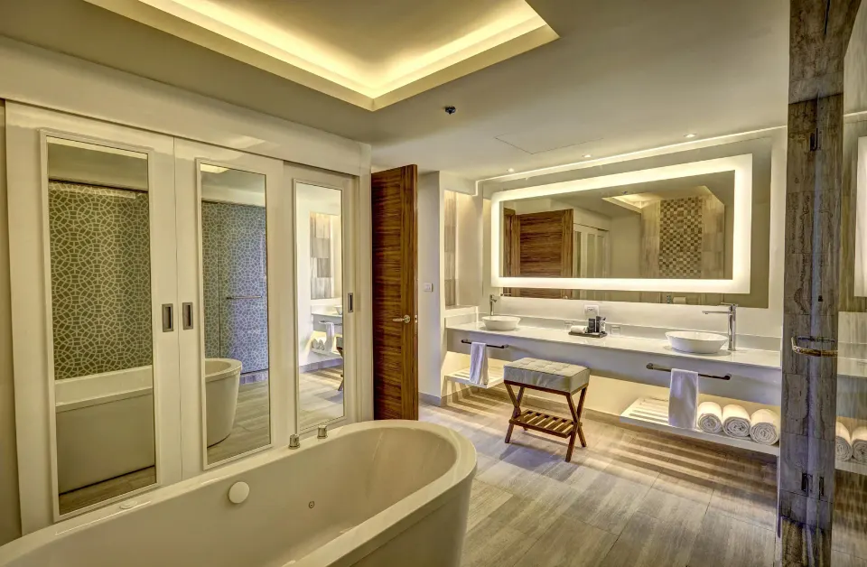 Luxury Presidential One Bedroom Suite bathroom with tub at Royalton Bavaro Resort & Casino.