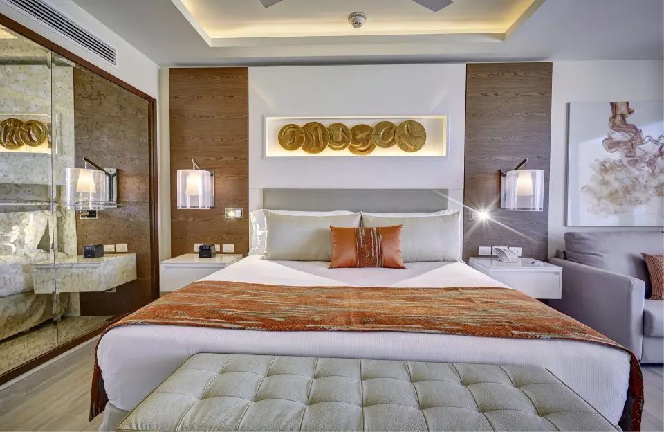 Luxury Presidential One Bedroom Suite king bed and sofa at Royalton Bavaro Resort & Casino.