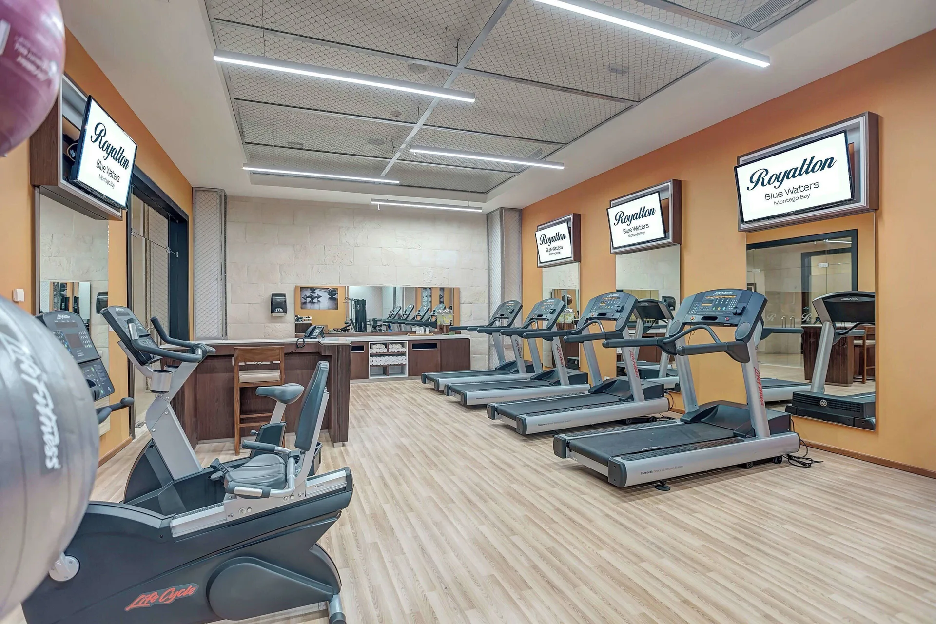 Fitness center with treadmills, mirrors, and cardio machines at Royalton Blue Waters Montego Bay.