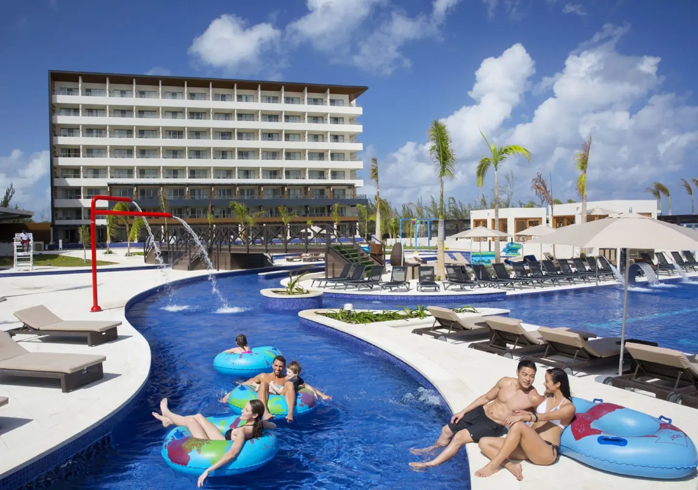 Guests float in the lazy river near pool loungers at Royalton Blue Waters Montego Bay.